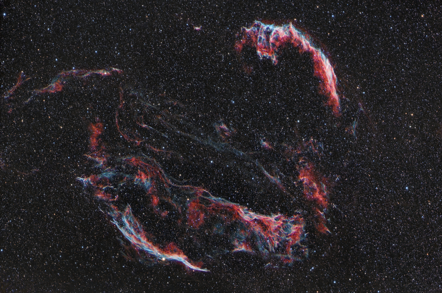 The Askar FRA300-Pro and AM3n using the ASI2600MC-Pro and my Dualband Hα_\alpha+OiiiO_{iii} filter were pointed at the Cygnus Loop, Sh2-103, a supernova remnant roughly 2,500 light-years away. Covering a whopping three degrees (about six Full Moons) in the night sky, it frames well in the Askar&rsquo;s larger FoV. Formed around 20,000 years ago by the core collapse of a massive star, its delicate, filaments glow brightly as the expanding supersonic shock front collides with and excites the surrounding interstellar medium, producing brilliant Hα_\alpha and Oiii_{iii} emissions.