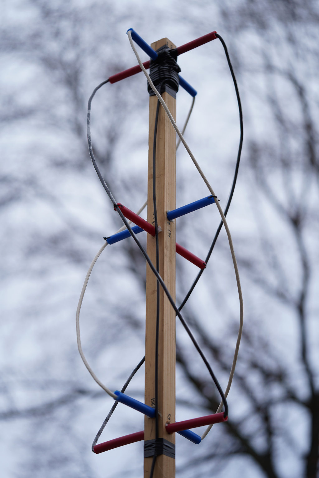 The QHF antenna I built with some spare parts and RG-58. Note the turnstile components connected together with for short helical wires.